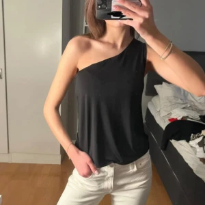Svart offoulder topp - Snygg svart oneshoulder topp. Jättefin och går att matcha till allt möjligt. Utan prislapp men aldrig använd🥰