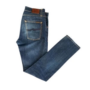 Nudie Jeans - Jeans från Nudie Jeans i storlek W32 L36. Snygga blå jeans med klassisk design. En liten skada syns på fjärde bilden, men i övrigt i mycket fint skick. Bara att höra av dig om du har några frågor!
