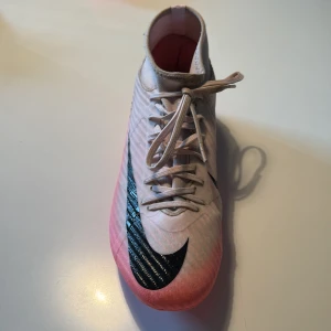 Nike Mercurial Superfly 9 Academy - Säljer ett par snygga Nike fotbollsskor i ljusrosa med svart swoosh på sidan.