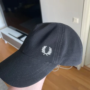 Fred perry keps - Klassisk ”gubbkeps” från fred perry som bara ligger i garberoben numera, går att justera storlek med hjälp av remmen där bak. 