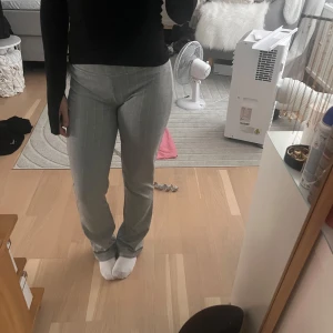 Grå randiga kostymbyxor från Nelly XS - Snygga grå kostymbyxor från Nelly i storlek XS. Byxorna har vita smala ränder. Jag har sytt upp dom men extra tyget är inte avklippta så om de är för korta för dig är det bara att sprätta upp tråden. Säljer då jag inte tycker de är så snygg på mig 