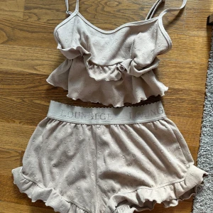 Beige pyjamas med volang från Lounge - Supersöt beige pyjamas från Lounge med tunna axelband och volangdetalj framtill, perfekt för chill dagar hemma.