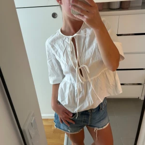 Söt topp från H&M - Kortärmad blus med knytning från H&M, perfekt till vardags eller fest <3 Nästintill oanvänd.