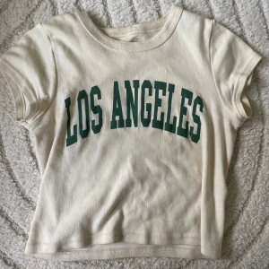 Brandy Melville topp✨ - Säljer en vit croppad t-shirt från Brandy Melville. Den är endast använd ett fåtal gånger och har därmed inga defekter. Passar perfekt till jeans eller shorts för en avslappnad stil. 🌟