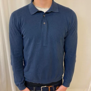 Blå långärmad pikétröja från Massimo Dutti - Säljer en fet blå långärmad pikétröja från Massimo Dutti. Den är i bra skick och skönt tunt material, perfekt till sommaren. Skriv för frågor eller likande 