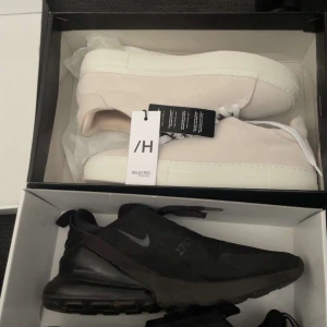 Svarta Nike Air Max och vita sneakers - Säljer ett par svarta Nike Air Max 270 luftbubbla och ett par vita minimalistiska sneakers från selected hoome. Nike-skorna har sportig design och de vita sneakersen har en clean look med vit sula och snörning. Säljer dem vita skorna för 800. Dem är helt nya använda en gång kvitto och box finns. Ny pris på dem är 1,3. Nike air Max 270 kostar ungefär 1,2 i ny pris. Säljer för 600. Pris kan sänkas vid snabb affär eller om du köper båda😁