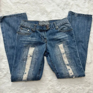 Lågmidjade bootcut jeans med slitningar vintage y2k 2000s  - Vintage jeans, storlek 10/s. Innerbenslängd: 78-79 midjemått:38. Det kan saknas några ”diamanter” på vissa ställen men inget man tänker på. Köp sker via köp nu, jag postar inom 24h. Kvar tills markerad såld.