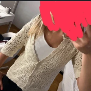 Beige stickad kofta med knappar - INTE MIN BILD!!Säljer en superfin beige stickad kofta med v-ringning och knappar framtill. Koftan har ett snyggt hålmönster och trekvartsärmar, perfekt att slänga över en t-shirt eller linne. Enkel att styla och ger en chill men ändå söt vibe.
