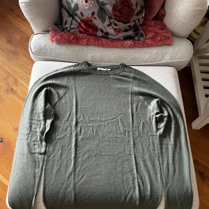 Grön tröja från 157 - Säljer en stilren grön tröja från 157 i storlek S. Tröjan har långa ärmar och en klassisk rund halsringning. Perfekt för en avslappnad look.