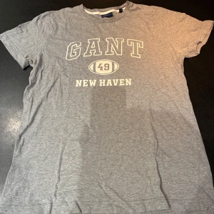 Grå GANT t-shirt - Snygg grå t-shirt från GANT size M! Sjukt go och snygg att ha som den är eller att ha den under någon halvzip! Hör av er vid funderingar! 