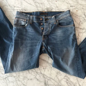 Nudie jeans Grim Tim W32 L32 - Väldigt bra skick på dessa Nudie jeans i model Grim Tim strikey favorite.