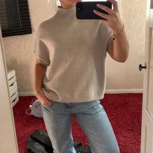 Beige polotröja - En beige polotröja med korta ärmar från Kappahl.