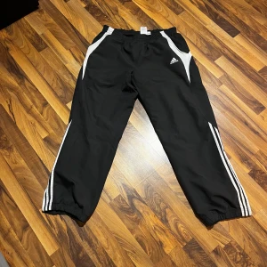 Vintage Adidas windbreakers - Vintage adidas windbreaker byxor som e bra för träning men också jättesnygga med vanliga kläder. Har en sip funktion nere ved benet.