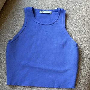 Blå ribbad linnetopp från Zara - Säljer en snygg blå ribbad linnetopp från Zara. Perfekt för varma dagar med sin ärmlösa design och bekväma passform. Ett måste i garderoben för en stilren look!
