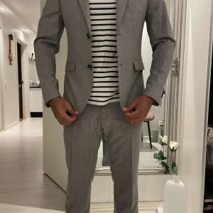 Grå kostym från Riley Shelby, stl 50 - Snygg grå kostym från Riley Shelby i storlek 50. Tillverkad i en mix av ull och polyester för en stilren look. Perfekt för dig som vill ha en clean och modern stil😁.Priset går att diskutera😊