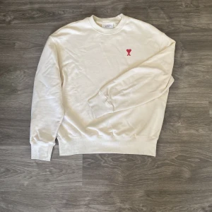 Sweatshirt från Ami Paris - Säljer en stilren beige sweatshirt från Ami Paris. Perfekt för en avslappnad, men även elegant look. Skick 8/10 nypris ca 2999kr. Vid snabb affär är mitt pris diskuterbart! 