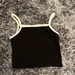 Svart ribbad linnetopp från H&M - Enkel och stilren modell som är perfekt till sommaren. Mjuk och stretchig bomullskänsla, passar dig som gillar minimalistisk stil. Använd 1 gång, perfekt skick🤍