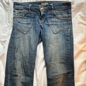 Lågmidjade jeans med nitar  - Super snygga jeans med coola detaljer och  fickor!💜Lågmidjade bootcut med snygg tvätt. Storlek 26/32 men stretchigt tyg🙂