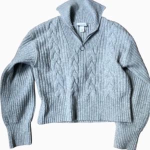 Grå stickad half zip tröja - Supermysig grå stickad tröja från Monki med half zip och hög krage. Tröjan har ett snyggt kabelstickat mönster framtill och ribbade muddar. Perfekt för lager-på-lager och chill dagar. Jätte lätt att styla då den passar till allt och året om. Jätte bra skick som ny. Hör av dig vid några frågor💓