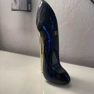 Good Girl parfym från Carolina Herrera - Säljer en ikonisk Good Girl parfym från Carolina Herrera i en snygg flaska formad som en högklackad sko. Flaskan är mörkblå med gulddetaljer och rymmer 80 ml. Perfekt för dig som gillar lyxiga och unika dofter. 