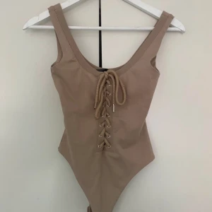 Maniere de Voir Bodysuit Nude Beige XXS XS - Nude beige Maniere de Voir lace up drawstring dragsko bodysuit. Thong snap close.  Too small 💔. Some loose threads, price reflects this. Moderately used condition . Orig 559 kr. No fading, stains, fuzz, pilling, tears, holes, or rips. Smoke/pet free home.