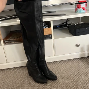 Svarta stövlar - Höga stövlar i läderimitation. 