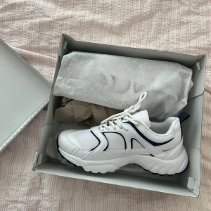 Skor - Helt oanvända sneakers ifrån Nelly, blåa detaljer.