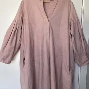 COS klänning - Härlig klänning i vid modell med fina detaljer. Piffig ärm och en fin siluett i ryggen. Använd, men i fint skick.