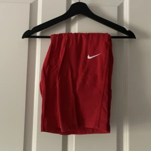 Nike shorts - Röda mjukisdjuret från Nike. Storlek small herr, lite lågmidjad modell. Ficka baktill. Små fläckar på bandet som kanske går bort i tvättmaskin, se bild 3, annars bra skick. 100kr+frakt