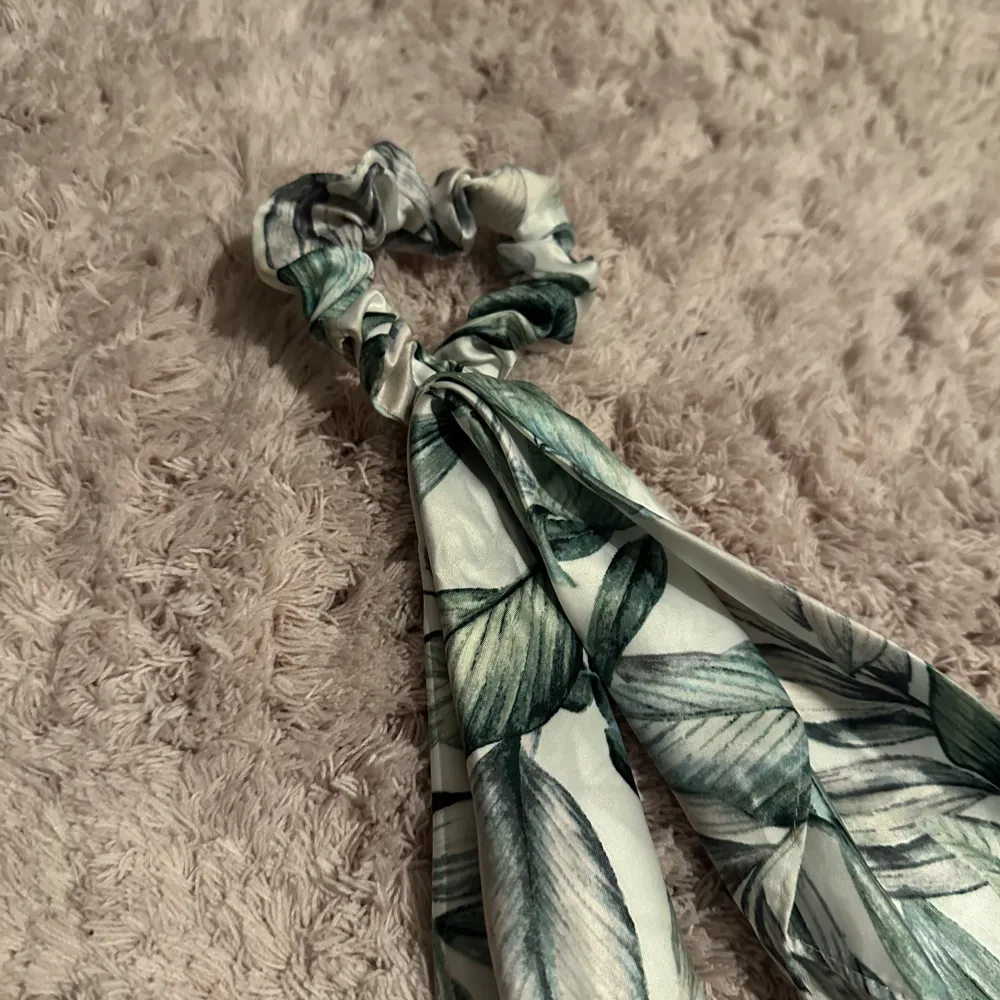 Hairtie from HM, used once, leaf pattern, white and green color. Accessoarer.