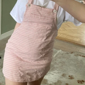 Hängselklänning  - Intressekoll på denna supersöta hängselklänning med ficka och fina knappar som är rosarutig! I bra skick & pris kan diskuteras🎀