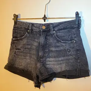 Korta jeansshorts från HM i svart med slitningar. Storlek 38 men väldigt stretchiga så funkar säkert för större storlekar. Skriv om du vill ha fler bilder! 