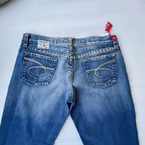 lågmidjade jeans - Riktigt snygga lågmidjade jeans🪩🪩 finaste blåa färgen, med as coola fickor och i nyskick💋 midjemått: 36-37 cm, innerbenslängd: 83 cm! Passar xs-s