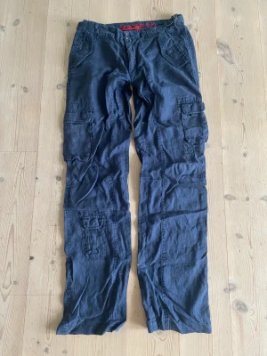 Cargobyxor - Snygga marinblå cargobyxor. De har ett litet hål baktil som knappt märks!❤️ Midja: 41cm Innerbensläng: 87cm Höfter: 49cm 