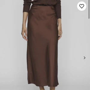 Brun satinkjol - Så fin brun satin kjol från Vila, aldrig använd! Säljer pga att den inte kommer till användning, stl 40 men skulle säga att alla mellan XS-M kan ha den!  Köpte den i stl 40 för att jag ville ha den längre men den sitter perfekt i midjan! Nypris 400kr❤️