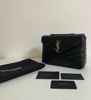 Yves Saint Laurent väska  - Säljer min Yves Saint Laurent Loulou väska som är helt oanvänd.  Dust bag och ett litet YSL kort följer med. Mer information privat 