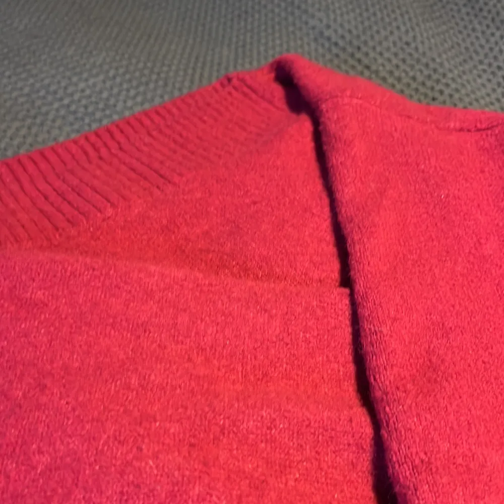 En stickad tröja i färgen lila/rosa, ser dock mer röd ut i kameran. I fint skick och är i storlek S. Stickat.