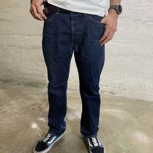 Levi’s 501 jeans - Säljer dessa snygga Levi’s 501 jeans då de är aningen stora. W32 L30. Modellen är 176cm och väger 66kg. Nypris;1099kr, mitt pris; 199kr då de har en liten slitning i grenen(se bild 3). Hör av er vid funderingar!