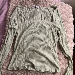 Grön topp från NAKD - Ljusgrön ribbad topp från NAKD. Använd fåtal gånger och har inga defekter alls. Väldigt tunt och luftigt material. 