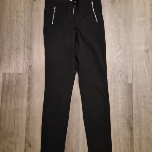 Kostymbyxa  - Ny kostymbyxa med dragkedjor fram och medel hög midja.