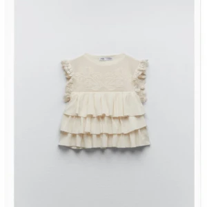 Zara topp/blus - Säljer denna jättefina volangtoppen med spets köpt från Zara. Den är HELT oanvänd, prislappen är dock tyvärr inte kvar☀️💞😊. Säljer för 399 då den är helt ny 🤙🏾. 60kr spårbar frakt 