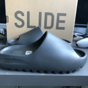 Yeezy slide  - Ett par yeezy slide onyx storlek 40,5 passar 39 skriv för mer bilder eller om ni undrar något 
