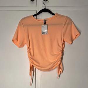 superfin neon orange ribbad t-shirt med knytning i sidorna. aldrig använd och lappen är kvar!🤩🧡✨