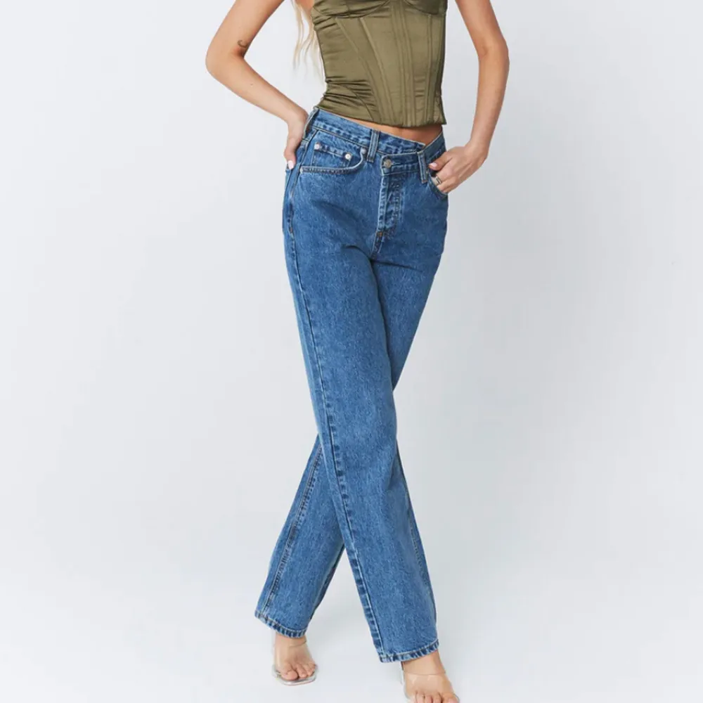 HOLLY ASYMMETRIC STRAIGHT MID WASH - nya jeans från princess polly säljer då jag köpt fel stolek, därav gick de sönder, en liten reva vid gylfen som är lätt att laga. Köpta för 1000kr (inkl tull & frakt). Pris kan diskuteras:) säljer så billigt pga skadan. Jeans & Byxor.