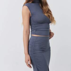 Populär kjol från Ginatricot i storlek S. Grå/blå färg. Lite mörkare i verkligheten skulle jag säga✨
