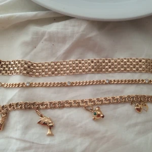 Xlänk, armband med stenar, bismarck med berlocker  - Xlänk : 18 karat guld  Vikt  21.00 gram Bredd 12 mm Längd 19 cm  Pris:10 000kr  Armband med stenar: 4000  Bismarck med berlocker 12.000