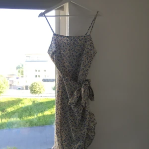 Söt blommig klänning - Sitter jätte fint på, ganska tajt i midjan.