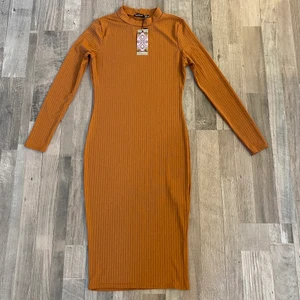 Boohoo Ribbed High Neck Long Sleeved Midi Dress - Description: Boohoo Ribbed High Neck Long Sleeved Midi Dress BRAND NEW with tag  Size: UK 10/ US 6/ EUFR 38/ EUDE 36 Material: 100 % polyester  Condition: Good/New