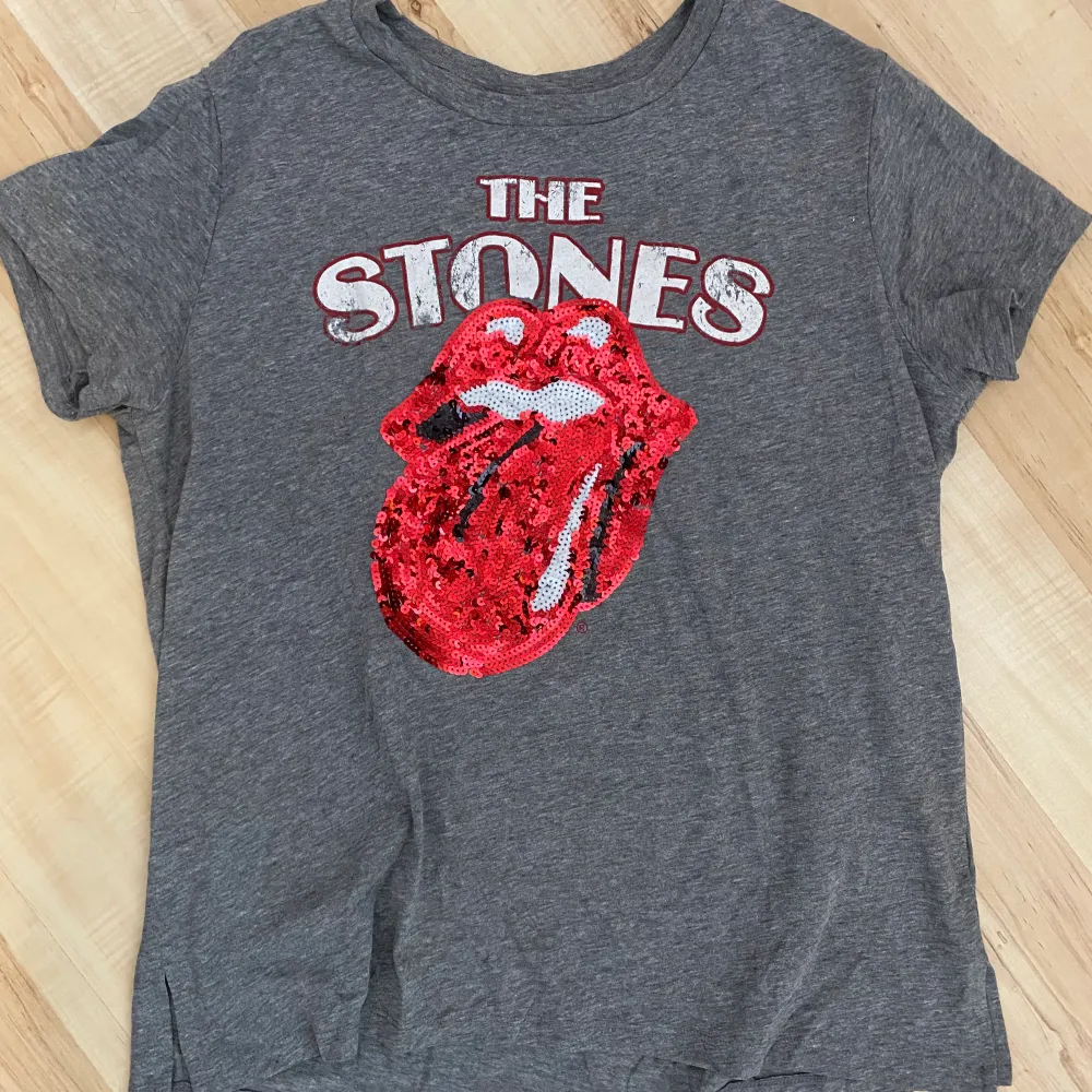 T-shirt med Rolling Stones motiv i paljetter. Fint skick! Skickas med spårbar frakt alt postnords blåa påse som köparen står för. . T-shirts.