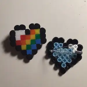 Minecraft heart pins perfect to go on bags. I have many colours so message me to ask about that. I also do pride flags :) ❤️🎮